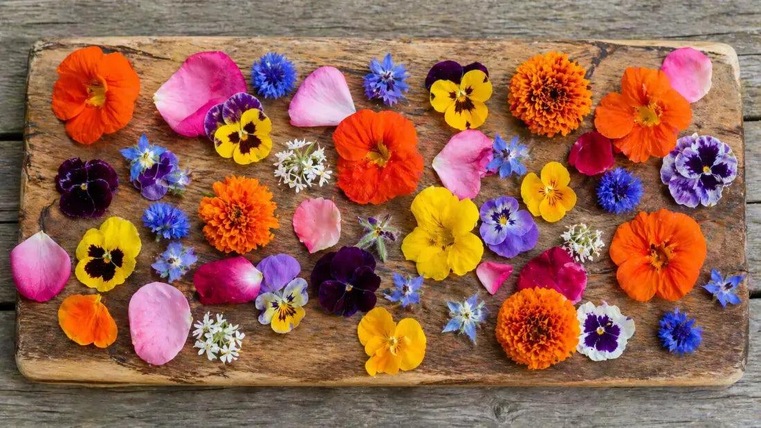Assorted edible flowers on wooden cutting board for cooking